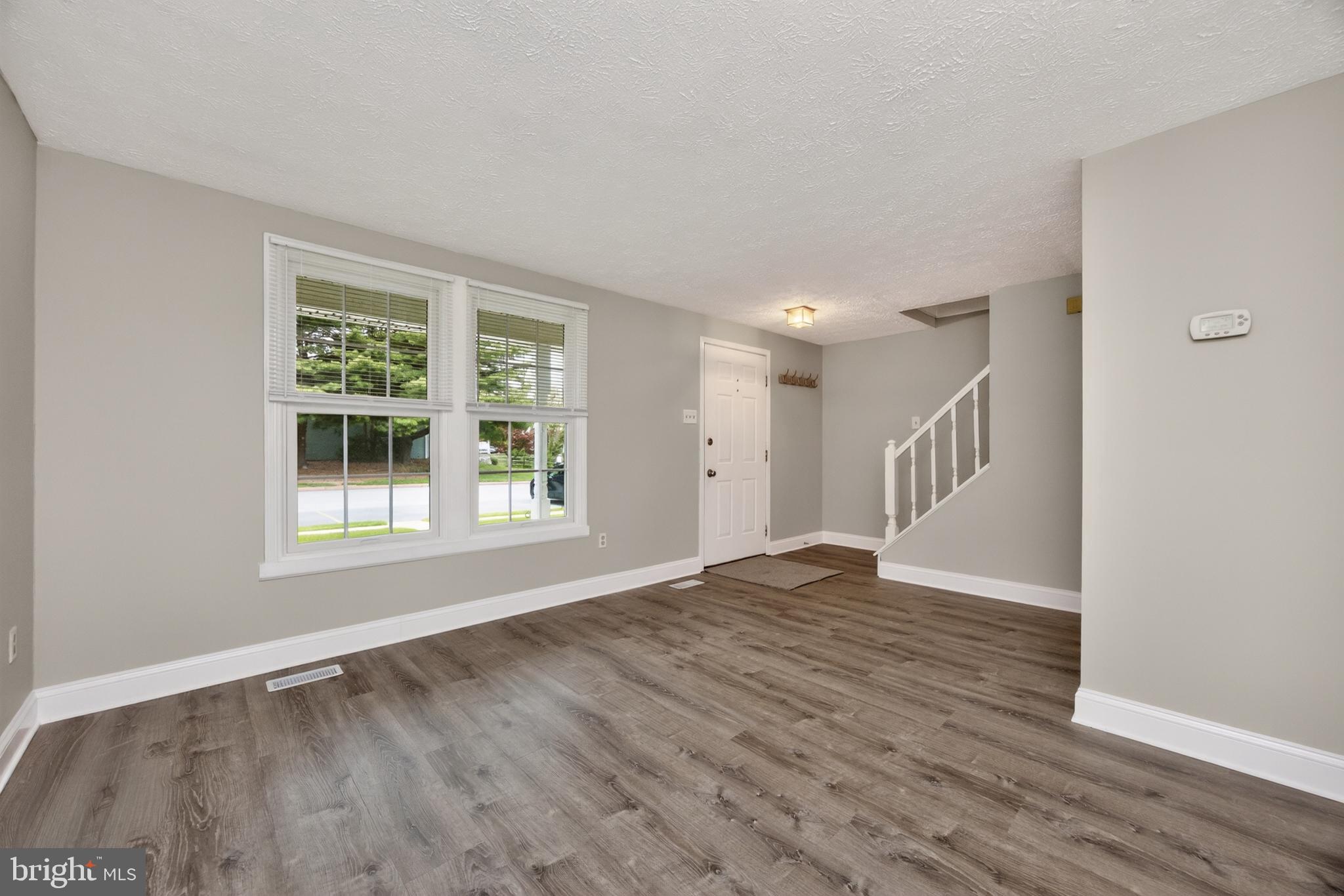348 Barclay Street Coatesville, PA 19320 - Photo 5 of 28 a view of an empty room with wooden floor and a window