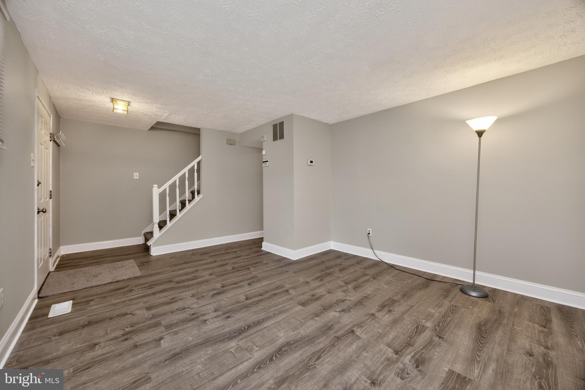 348 Barclay Street Coatesville, PA 19320 - Photo 6 of 28 a view of an empty room with wooden floor
