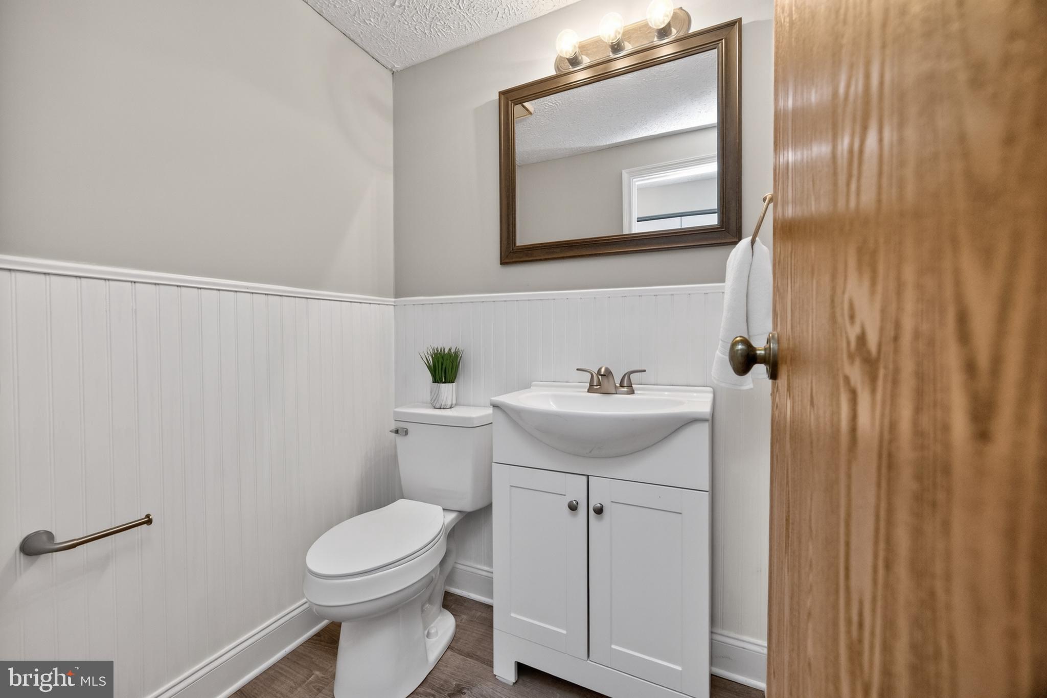 348 Barclay Street Coatesville, PA 19320 - Photo 8 of 28 a bathroom with a sink toilet and mirror