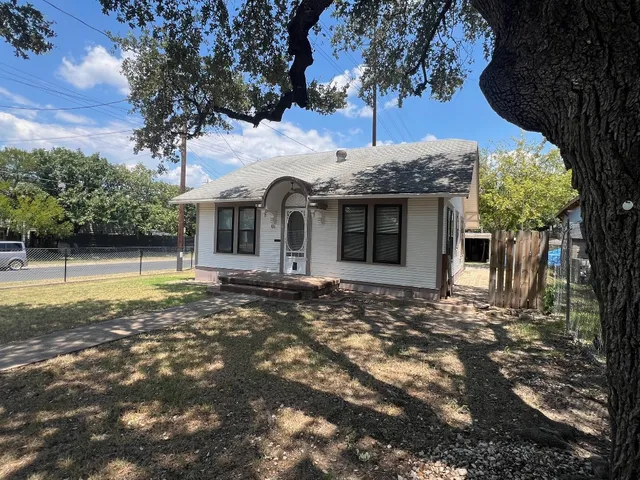 a view of a house with a large tree