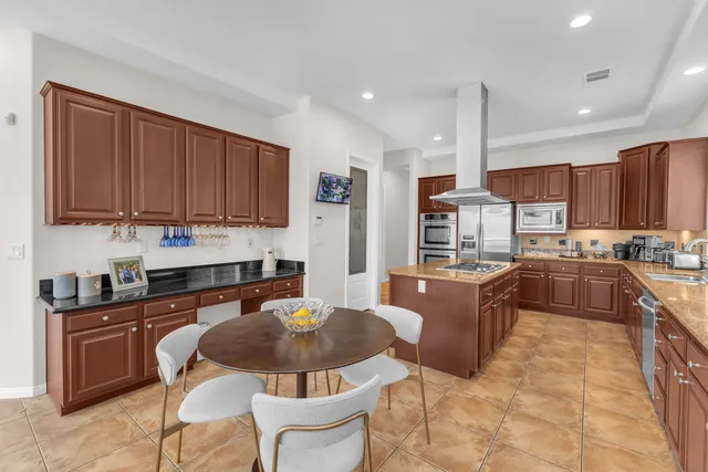an aerial view of residential houses with outdoor space and ocean view