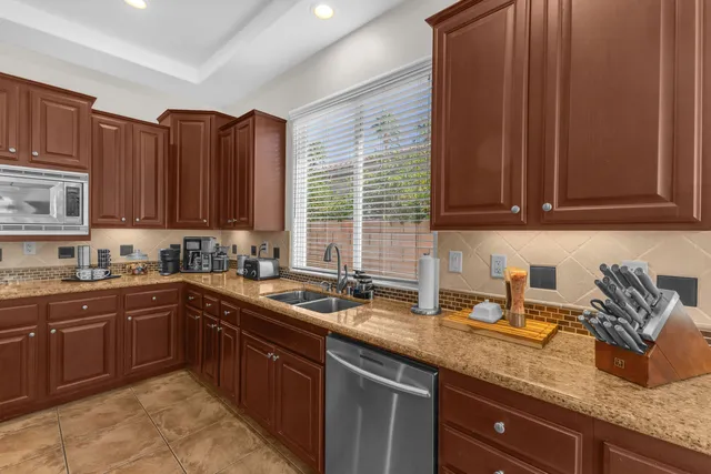 an aerial view of a house with a yard and a large tree