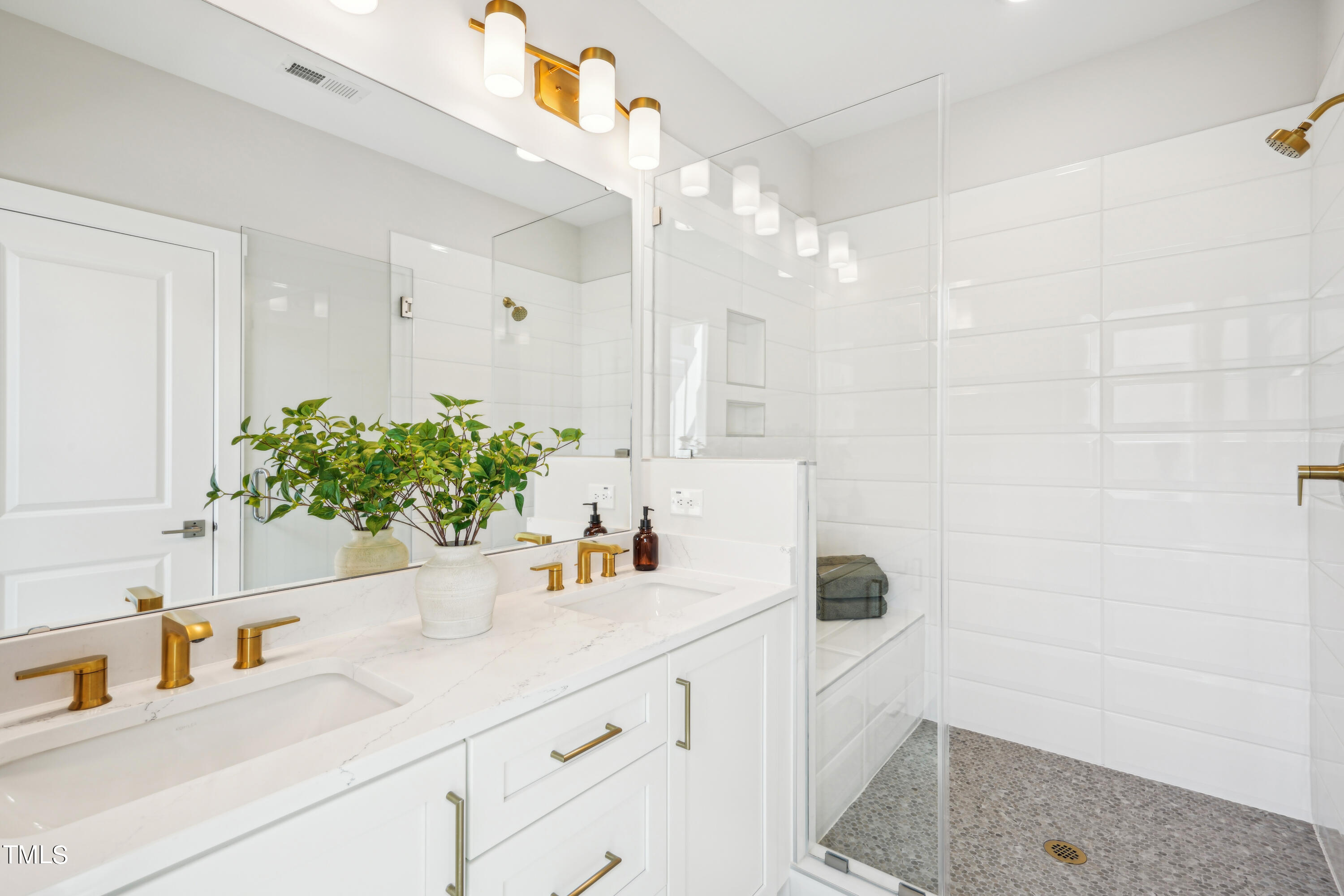 11549 Helmond Way, Unit 117 Raleigh, NC 27617 - Photo 12 of 34 a bathroom with a sink and a mirror