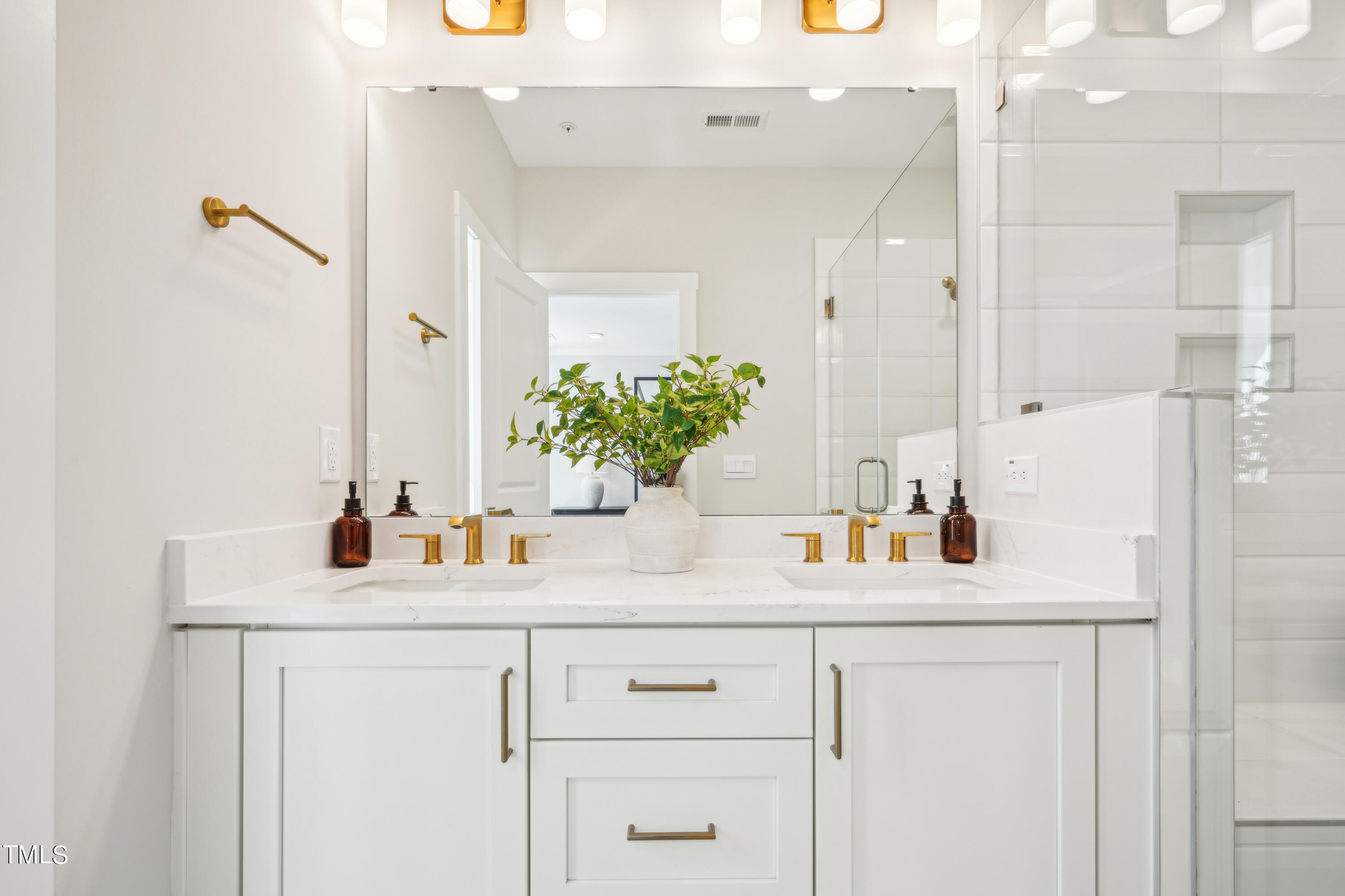 11549 Helmond Way, Unit 117 Raleigh, NC 27617 - Photo 13 of 34 a bathroom with a sink and a mirror