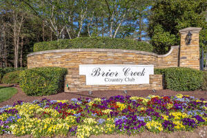 11549 Helmond Way, Unit 117 Raleigh, NC 27617 - Photo 20 of 34 a sign that is in front of flowers
