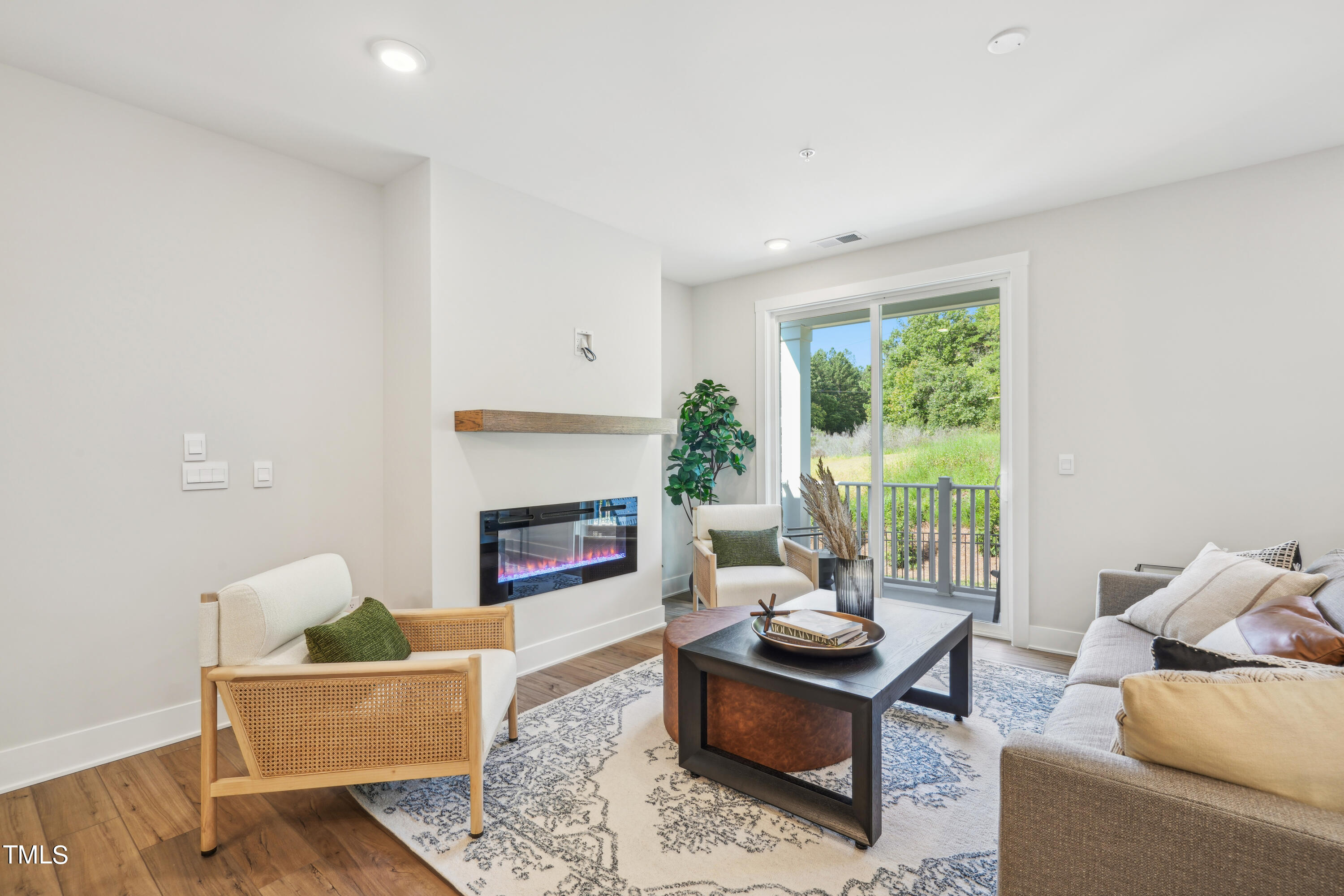 11549 Helmond Way, Unit 117 Raleigh, NC 27617 - Photo 6 of 34 a living room with furniture and a fireplace