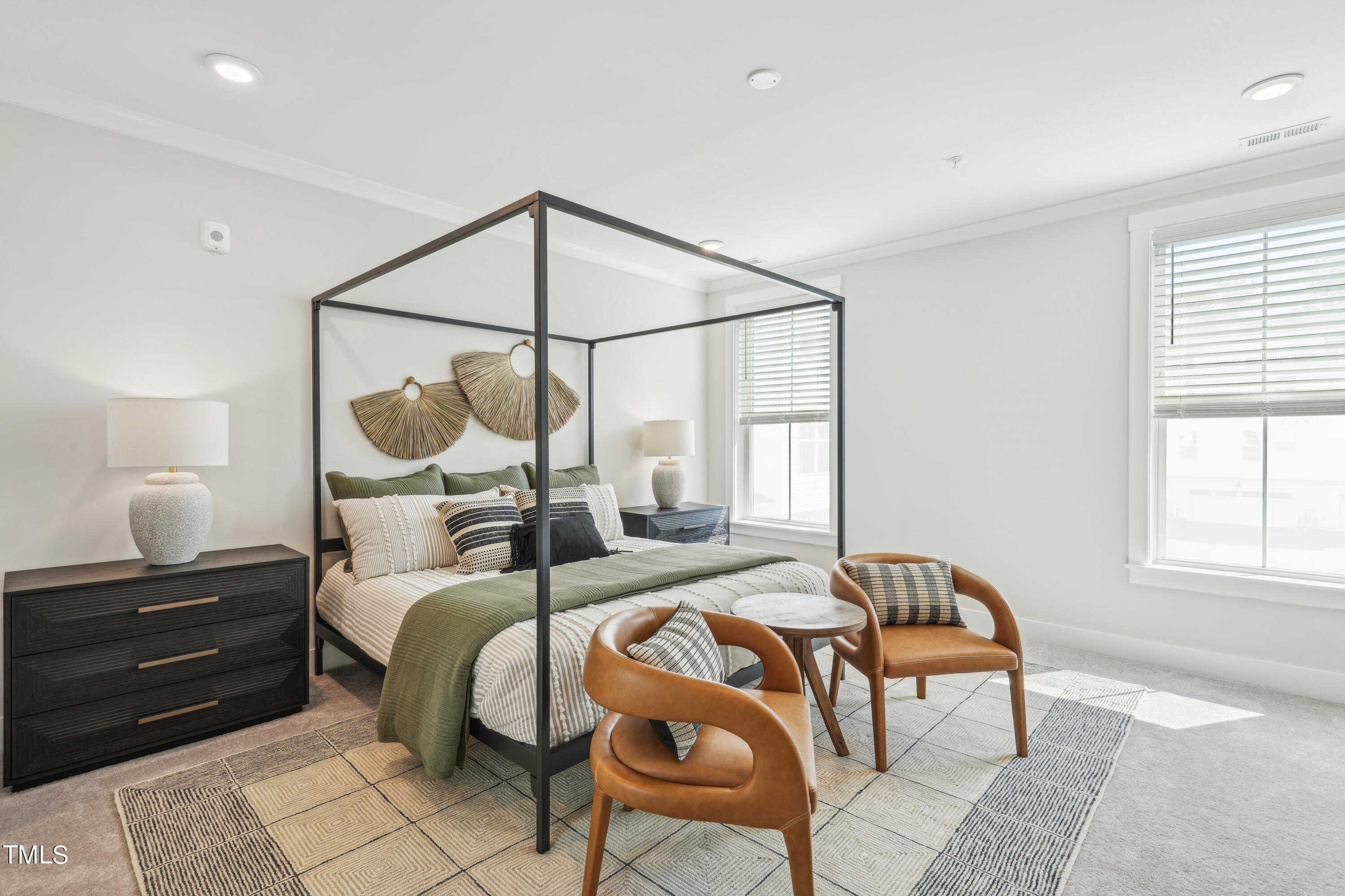 11549 Helmond Way, Unit 117 Raleigh, NC 27617 - Photo 10 of 34 a bedroom with a bed a mirror and a window