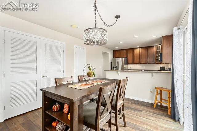 a view of a dining room with furniture wooden floor and a chandelier