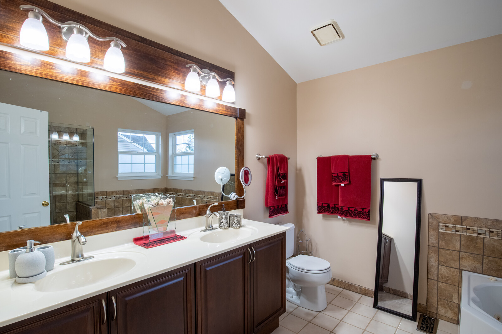 207 Faircroft Road Bartlett, IL 60103 - Photo 11 of 29 a bathroom with a toilet sink and mirror
