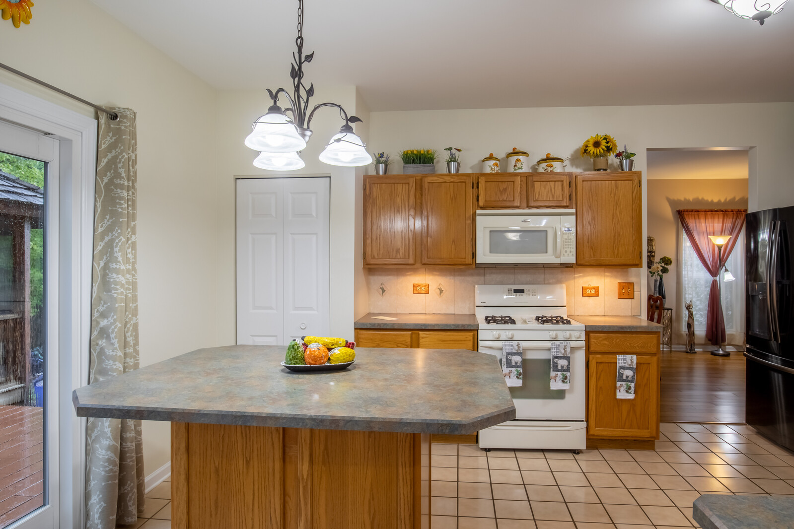 207 Faircroft Road Bartlett, IL 60103 - Photo 17 of 29 a kitchen with a sink and a refrigerator