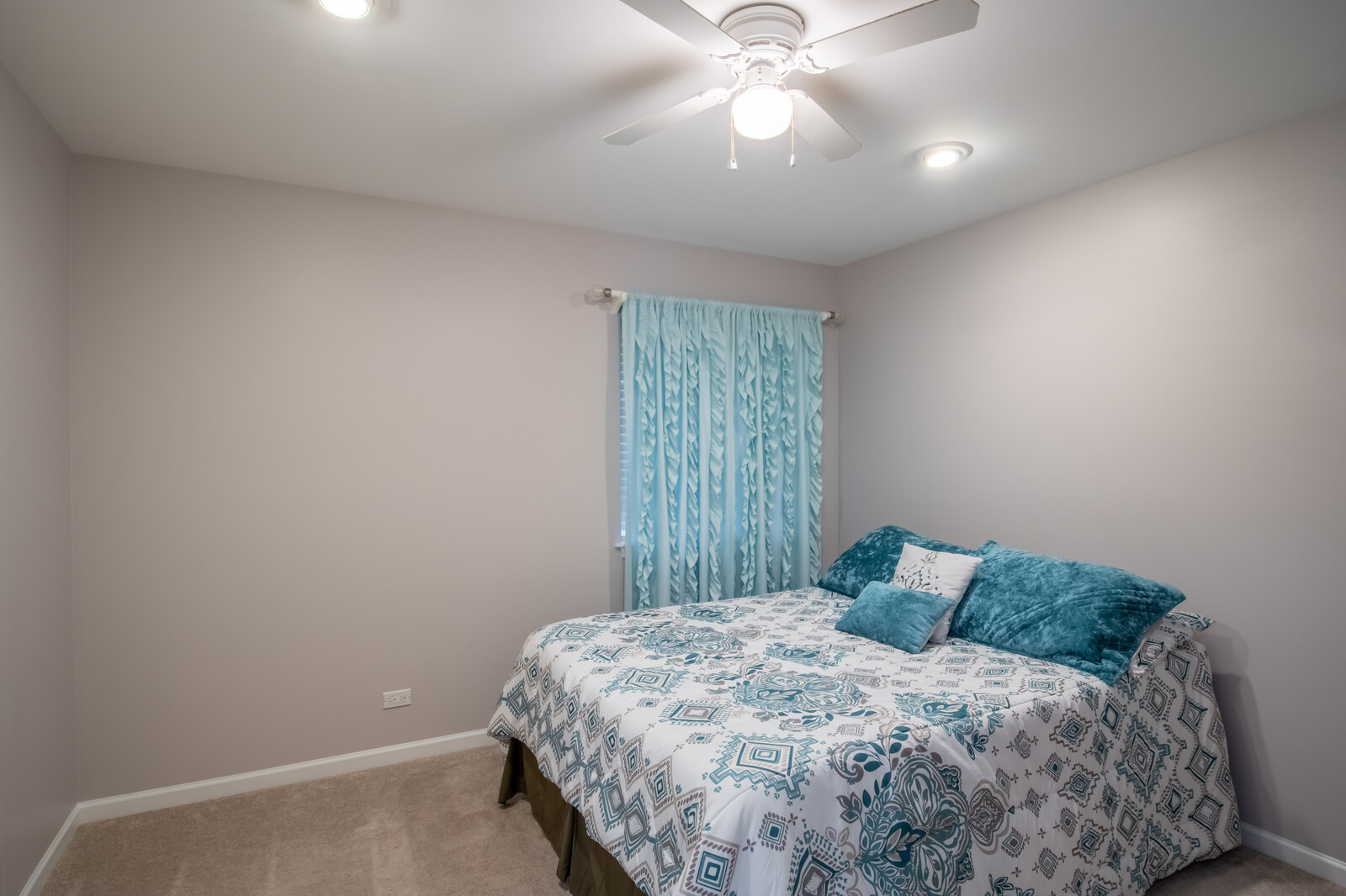 207 Faircroft Road Bartlett, IL 60103 - Photo 4 of 29 a bedroom with a bed and a chandelier