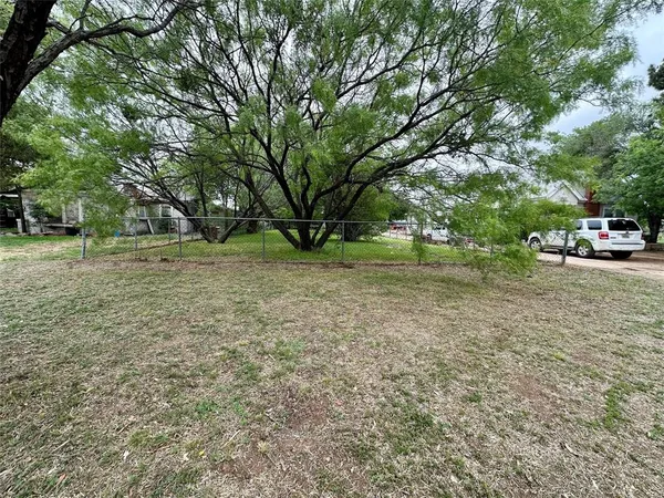 a view of a park with large trees
