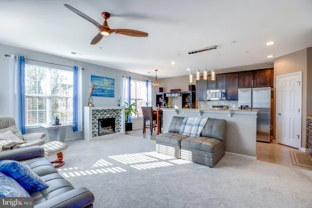 a living room with furniture and fireplace