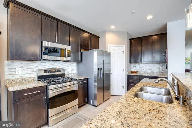 a kitchen with a refrigerator stove and microwave