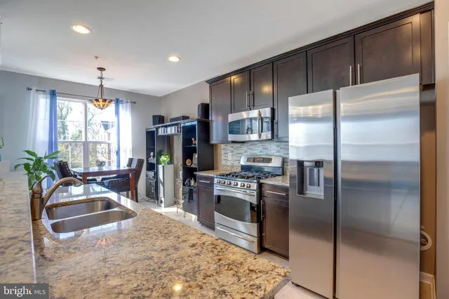 a kitchen with kitchen island a counter top space appliances and a counter space