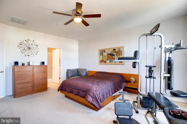 a bedroom with a bed dresser and a window