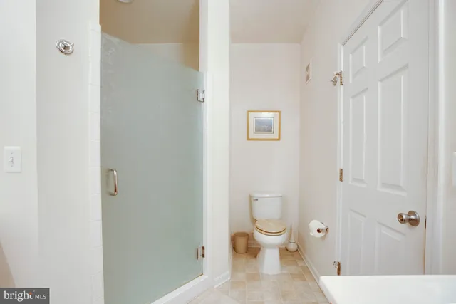 a white toilet sitting next to a bathroom sink
