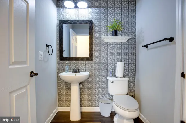 a bathroom with a toilet sink and mirror
