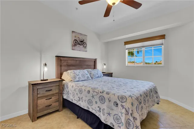 a bedroom with a bed and a ceiling fan