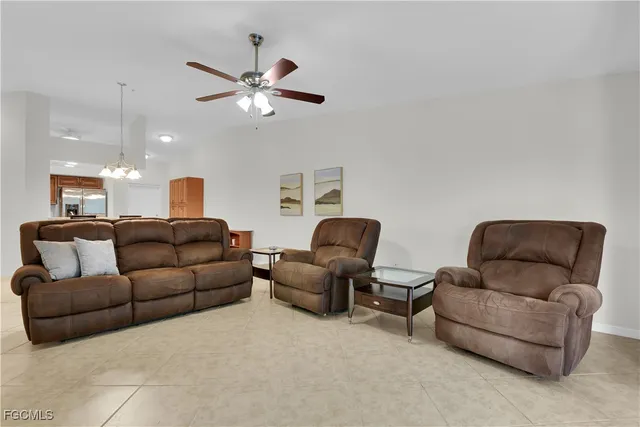 a living room with furniture and a ceiling fan