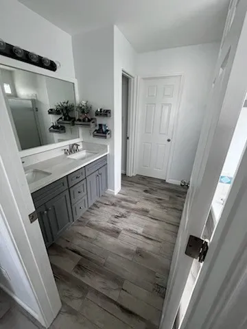 a bathroom with a sink a mirror and a shower