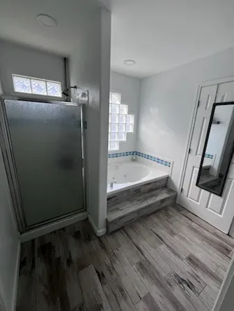 a bathroom with a tub and shower