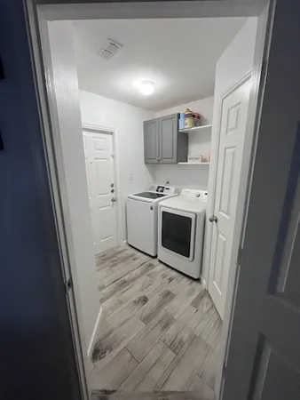 a view of a kitchen with a sink dishwasher stove and refrigerator