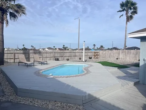 a view of a swimming pool with a table and chairs