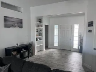 a view of a bedroom with wooden floor and closet