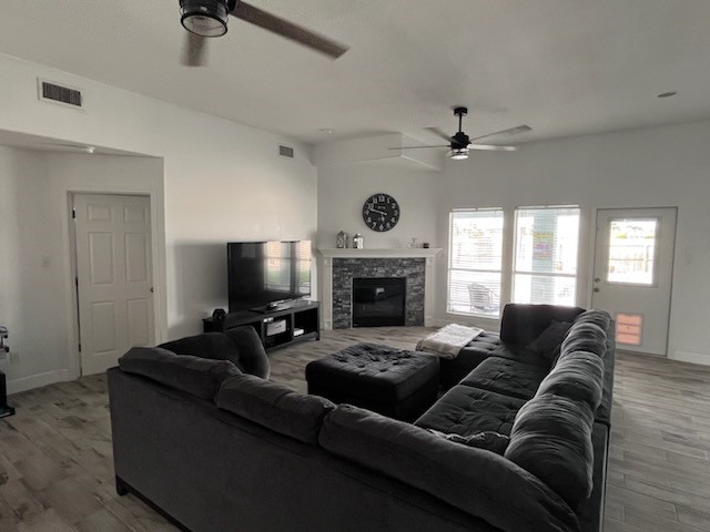 14010 Hawksnest Bay Drive Corpus Christi, TX 78418 - Photo 6 of 22 a living room with furniture a fireplace and a flat screen tv