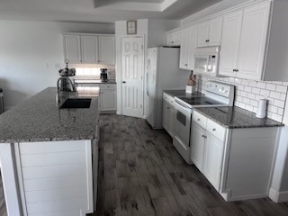 14010 Hawksnest Bay Drive Corpus Christi, TX 78418 - Photo 7 of 22 a kitchen with granite countertop a sink stove and refrigerator