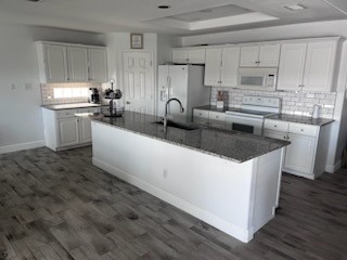 14010 Hawksnest Bay Drive Corpus Christi, TX 78418 - Photo 8 of 22 a kitchen with kitchen island granite countertop a sink appliances cabinets and a counter top space