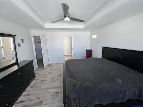 a bedroom with a bed and wooden floor