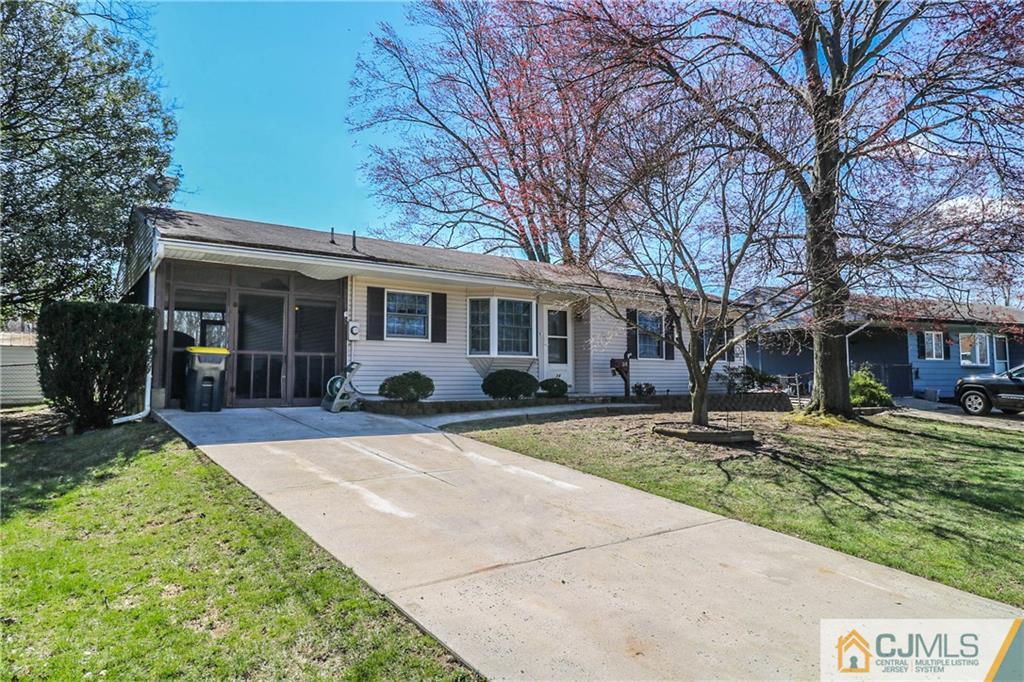 24 Purdue Road Old Bridge, NJ 08859 - Photo 2 of 25 a front view of a house with a yard and potted plants
