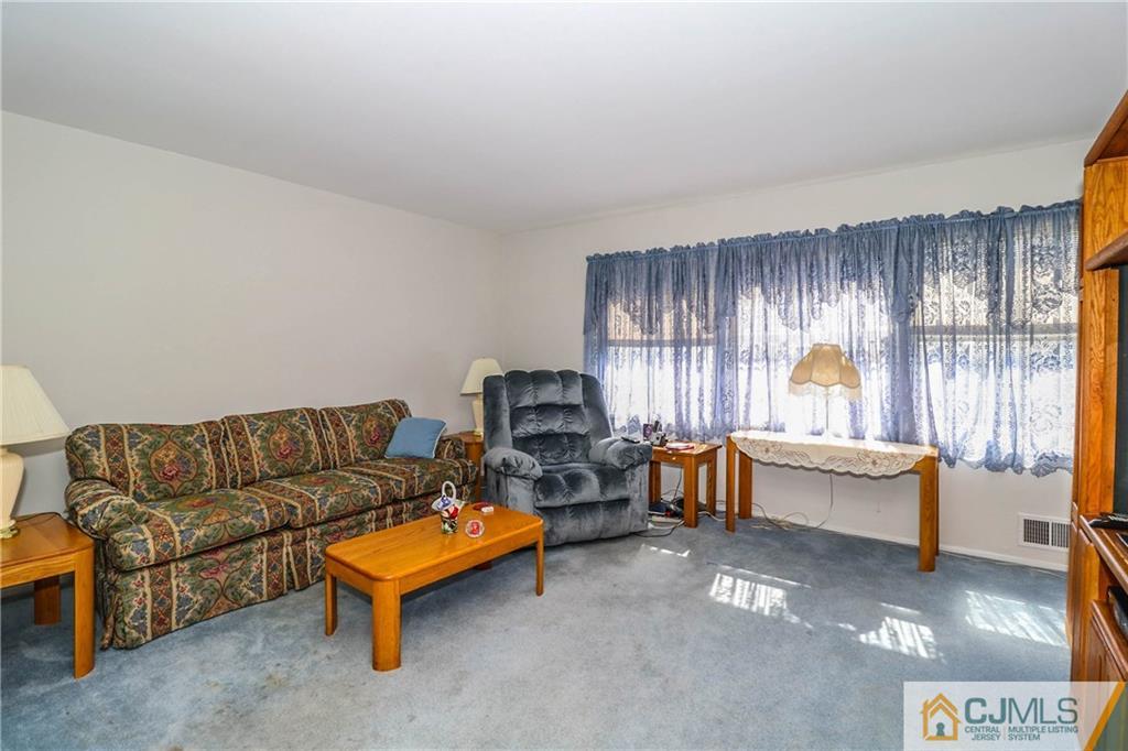 24 Purdue Road Old Bridge, NJ 08859 - Photo 11 of 25 a living room with furniture and a window