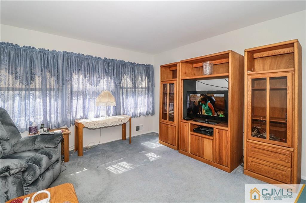 24 Purdue Road Old Bridge, NJ 08859 - Photo 12 of 25 a living room with furniture and a flat screen tv