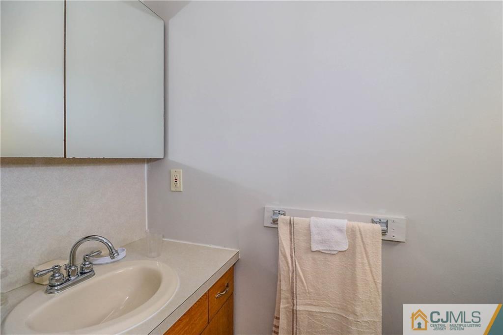 24 Purdue Road Old Bridge, NJ 08859 - Photo 17 of 25 a bathroom with a sink and vanity