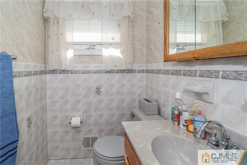 24 Purdue Road Old Bridge, NJ 08859 - Photo 21 of 25 a bathroom with a sink a toilet and shower