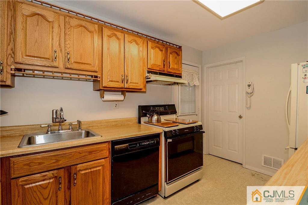 24 Purdue Road Old Bridge, NJ 08859 - Photo 5 of 25 a kitchen with stainless steel appliances granite countertop a stove a sink and a microwave