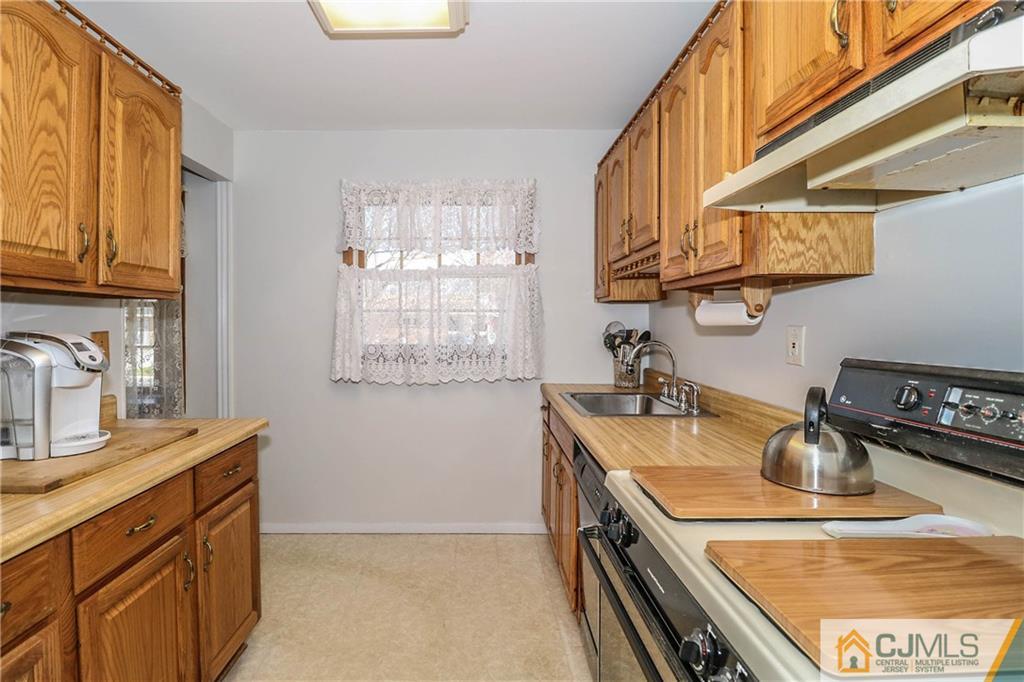 24 Purdue Road Old Bridge, NJ 08859 - Photo 6 of 25 a kitchen with sink a stove and cabinets