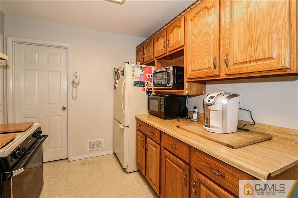 24 Purdue Road Old Bridge, NJ 08859 - Photo 7 of 25 a kitchen with stainless steel appliances granite countertop a stove and a sink