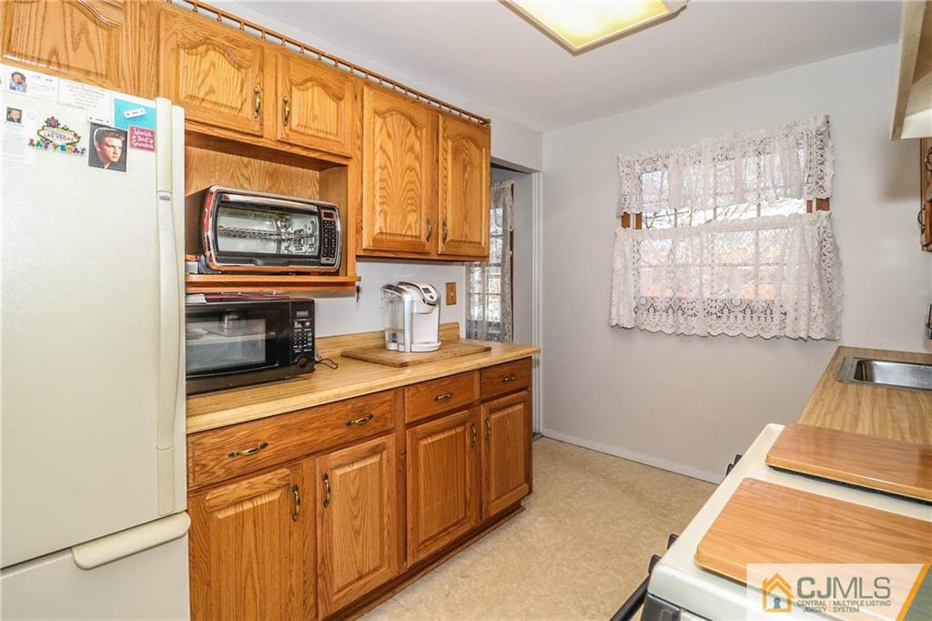 24 Purdue Road Old Bridge, NJ 08859 - Photo 8 of 25 a kitchen with stainless steel appliances granite countertop a sink a stove cabinets and wooden floor
