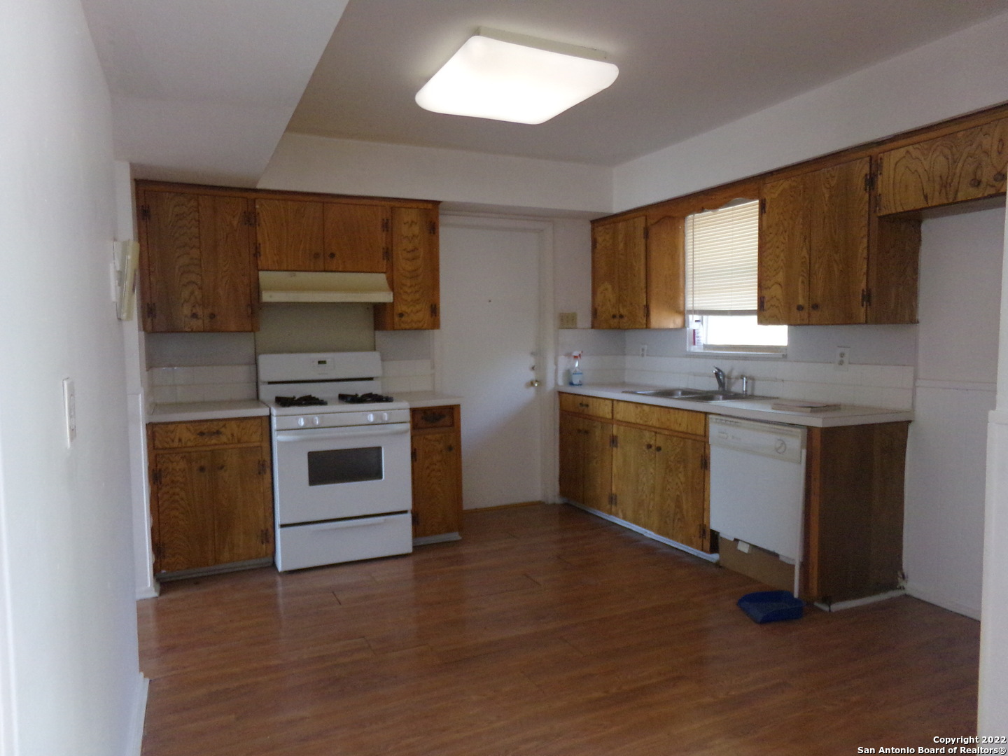 5975 Babcock Road San Antonio, TX 78240 - Photo 17 of 29 a kitchen with a stove a sink and a microwave