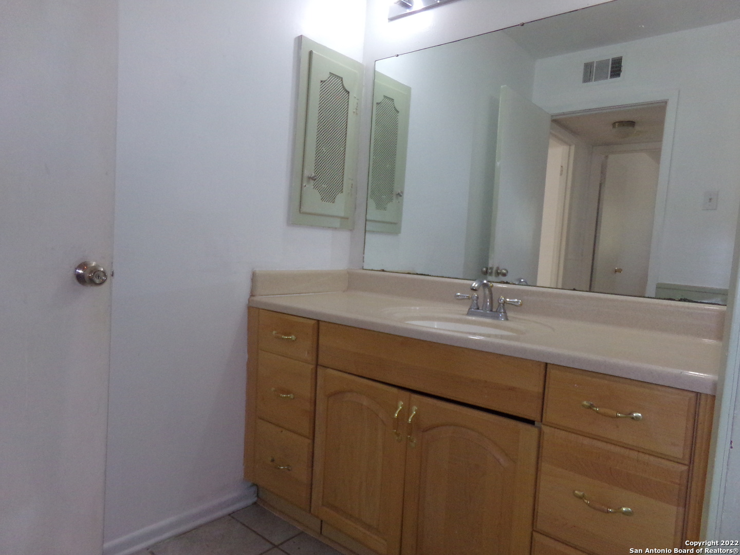 5975 Babcock Road San Antonio, TX 78240 - Photo 21 of 29 a bathroom with a granite countertop sink and a mirror