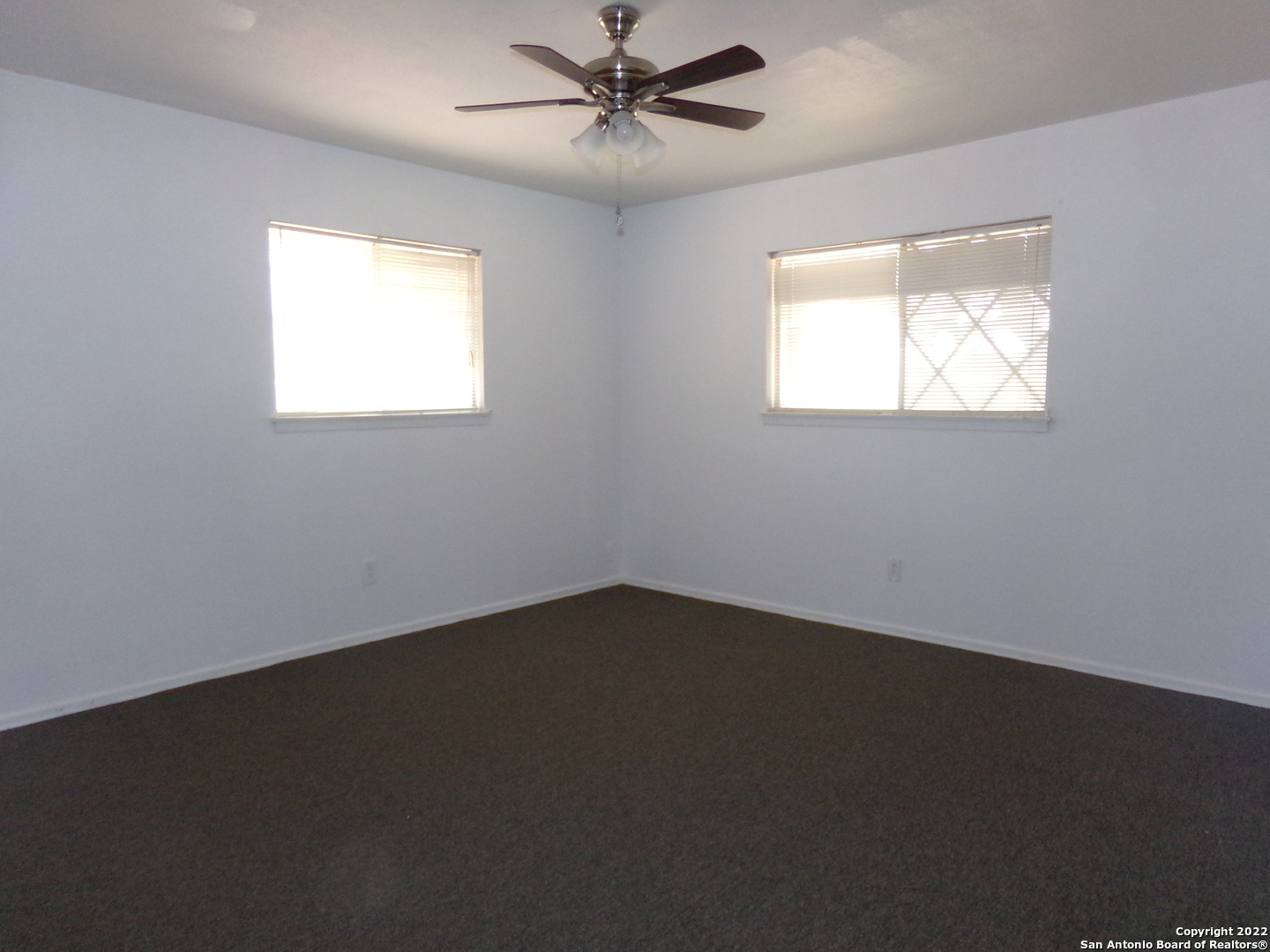 5975 Babcock Road San Antonio, TX 78240 - Photo 27 of 29 an empty room with a window and a ceiling fan