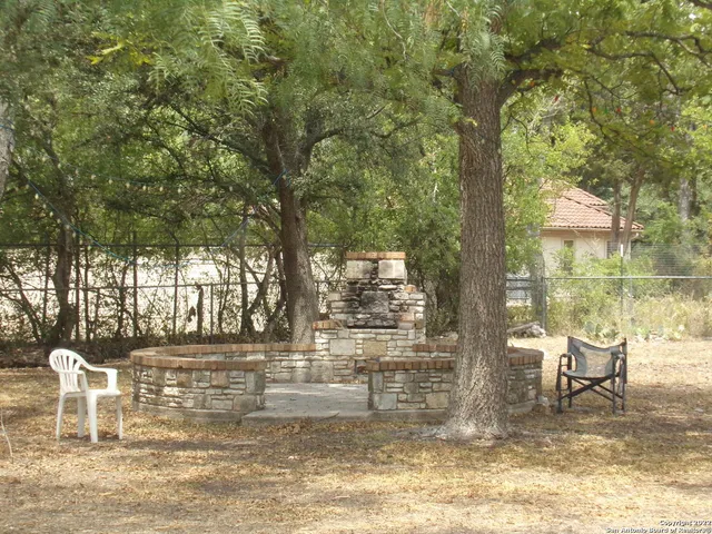 a view of a chairs and table in patio
