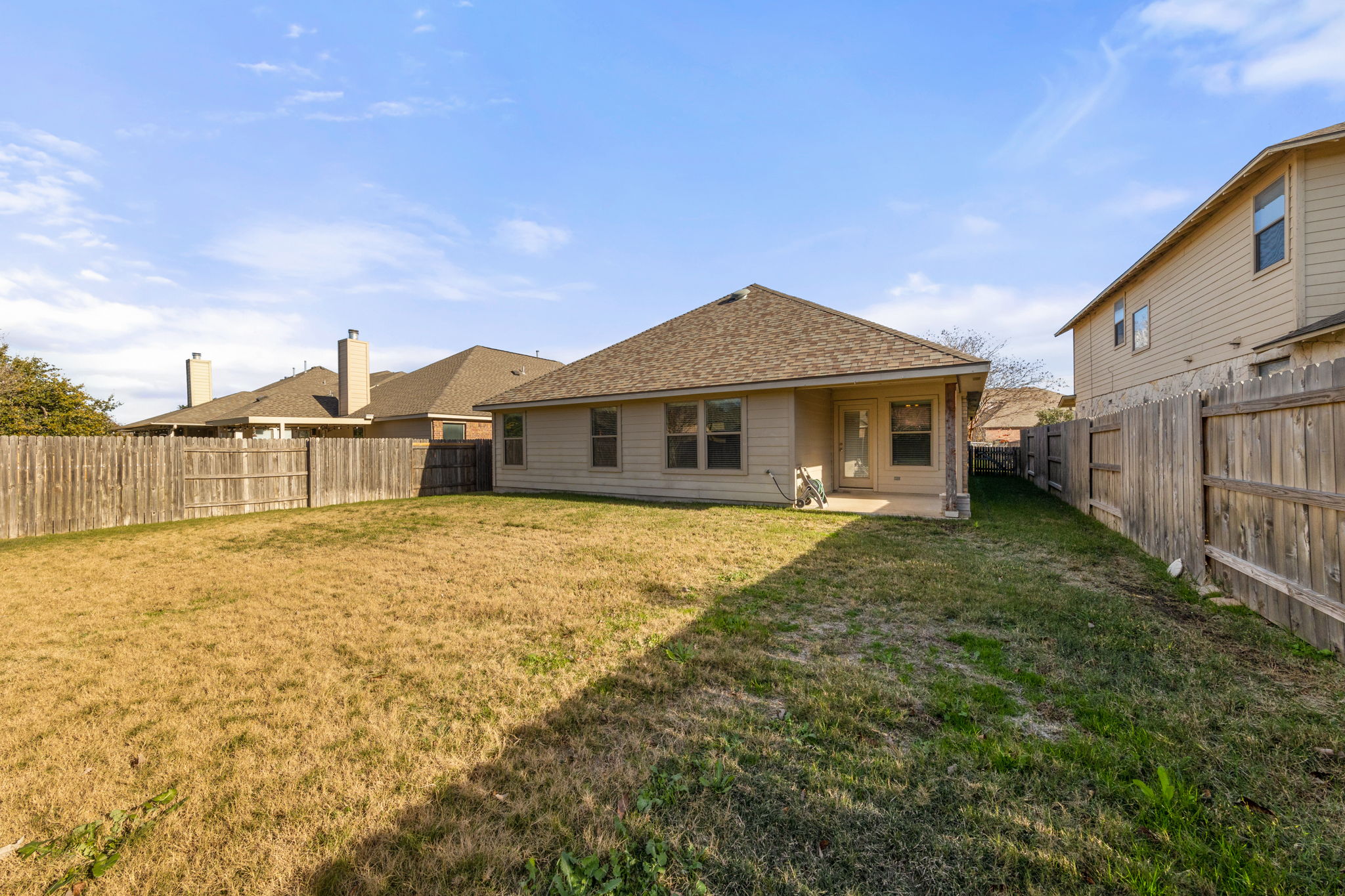 411 Tascate Street Georgetown, TX 78628 - Photo 37 of 41 A spacious backyard awaits, fully fenced for privacy and outdoor enjoyment.