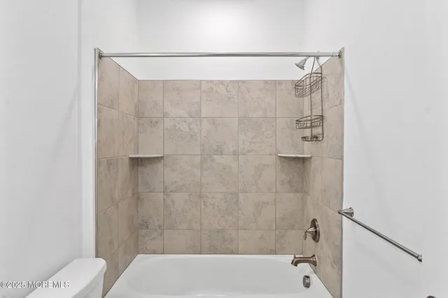 a bathroom with a shower and a toilet