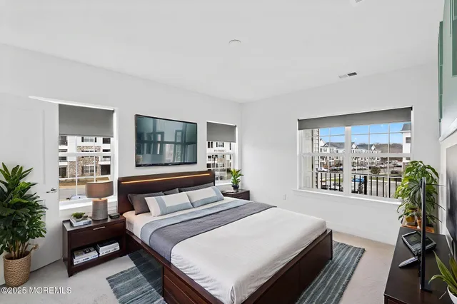 a bedroom with a large bed and a window