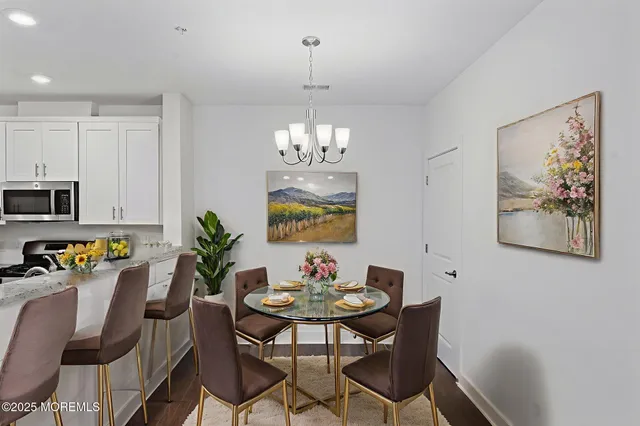 a dining room with furniture and chandelier